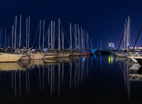 Yachts in marina at night