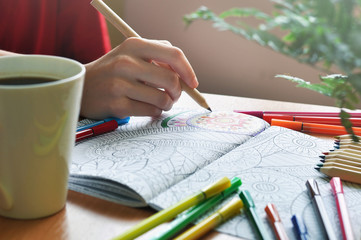 Coloring an adult coloring book