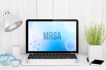 medical desktop computer with mrsa on screen