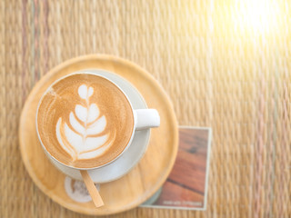 beautiful foam in coffee cup on table with sun light,selective f
