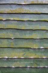 pattern of old green planks of shed with moss