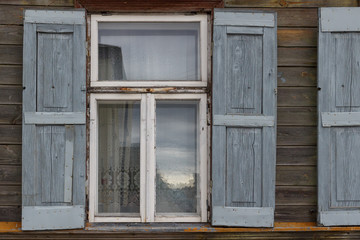 Naklejka na ściany i meble The building window with wooden shutters