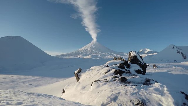 Volcanic landscape of Kamchatka: eruption Klyuchevskoy Volcano (Klyuchevskaya Sopka), gas-steam activity of volcano, explosive-effusive erupting. Klyuchevskaya Group of Volcanoes. (time lapse, 4K)