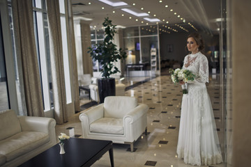 Stunning bride in a gorgeous dress stands in the middle of a hot