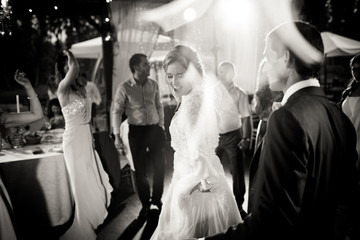 Lamps lights envelope a stunning bride dancing with guests