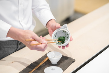 Master prepares Chinese tea leaves for home ceremony closeup concept image
