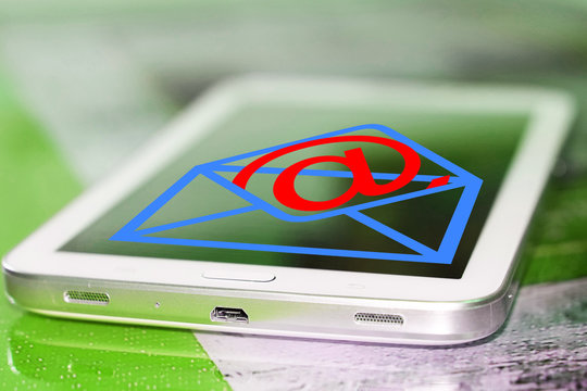 Email symbol on screen of cell phone . The concept of online correspondence .