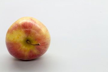 red apple on white table