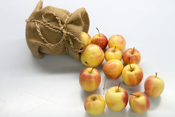 red apple in bag on white table