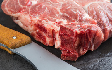 Piece of pork meat on a black stone table