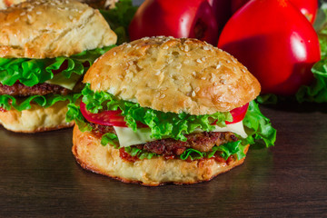 Close-up of home made tasty burgers on wooden table