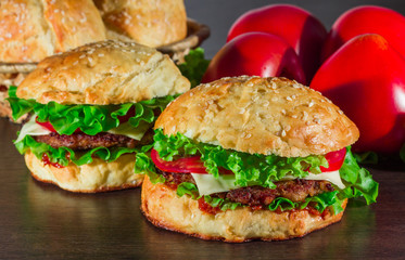 Close-up of home made tasty burgers on wooden table