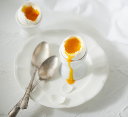 Soft boiled eggs on the white table