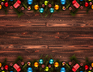 2017 Happy New Year seasonal background with real wood green pine, colorful Christmas baubles, gift boxe and other seasonal stuff over an old wooden aged background