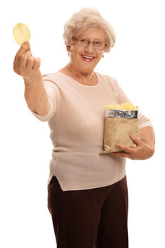 Woman Holding Bag Of Potato Chips And Single Chip