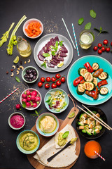 Colorful vegetarian feast dinner table from above