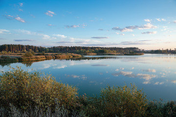 Fototapeta na wymiar Pond in countryside in autumn at sunset