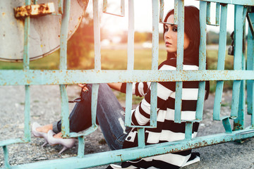 Fototapeta na wymiar Long hair girl outdoor with old fence behind