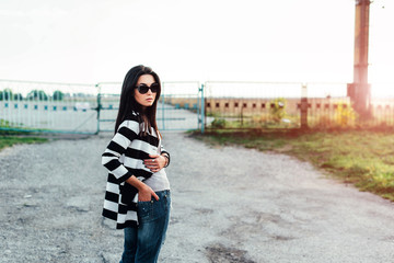 Long hair girl outdoor with old fence behind