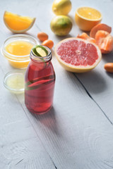 Fitness citrus cocktail on the white wooden table vertical
