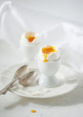 Soft boiled eggs on the white table