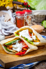 Fried chicken meat with vegetables in pita bread