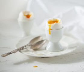 Soft boiled eggs on the white table