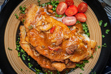 Potato pancakes with meat stew served on a plate.
