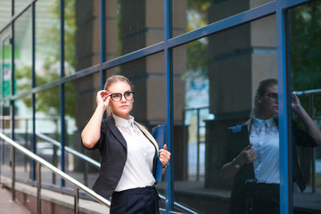 Business woman in glasses with papers and documents on the street