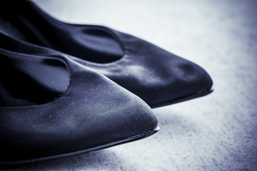 Vintage black shoes. Still life of a pair of old and elegant ladies shoes with high heel.