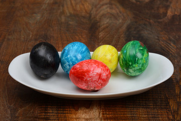 Set of Colorful Easter Eggs in Plate wood Background