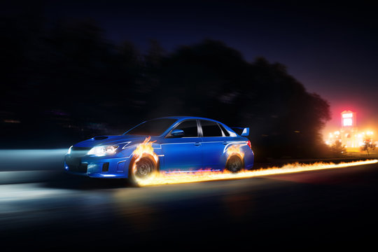 Blue Car Drive On Asphalt Countryside Road With Fire Wheels At Night