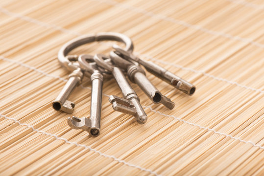 Old house keys, vintage key set with ring. Concept image of buying property, or home security.