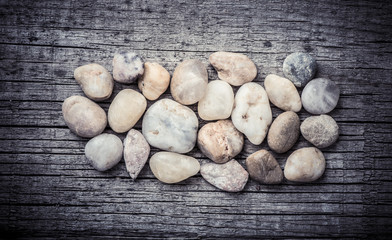 Stones on wooden background, concept of harmony and tranquility. Decoration with stone pebbles as natural design backdrop with copy space.