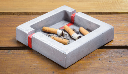 cigarette and ashtray on wood table