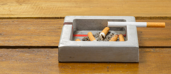cigarette and ashtray on table
