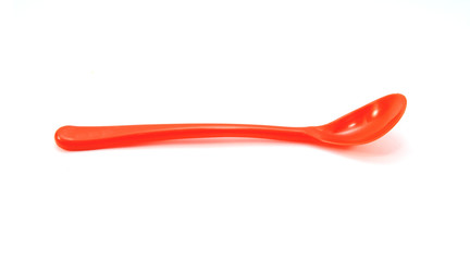 Red plastic spoon isolated on white background