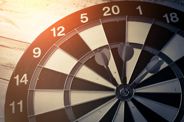 dart arrow hitting in the target center of dartboard