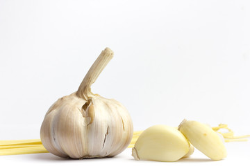 Two young garlic heads and cloves isolated on white background.