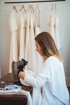 Female dressmaker sewing in the studio