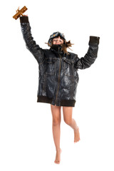 Young girl with pilot hat holding a wooden toy airplane