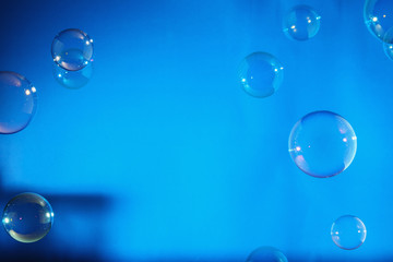 Rainbow soap bubbles on a blue backgrounds