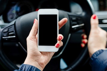 Woman holding a white smartphone with blank screen