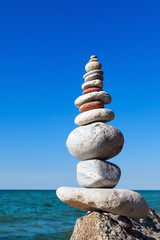 Fototapeta na wymiar Concept of harmony and balance. Rock Zen on the background of summer sea