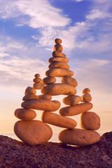 Fototapeta na wymiar Concept of harmony and balance. Rock Zen at sunset. Balance and poise stones against the sea