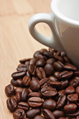 coffee beans and cup on wooden background