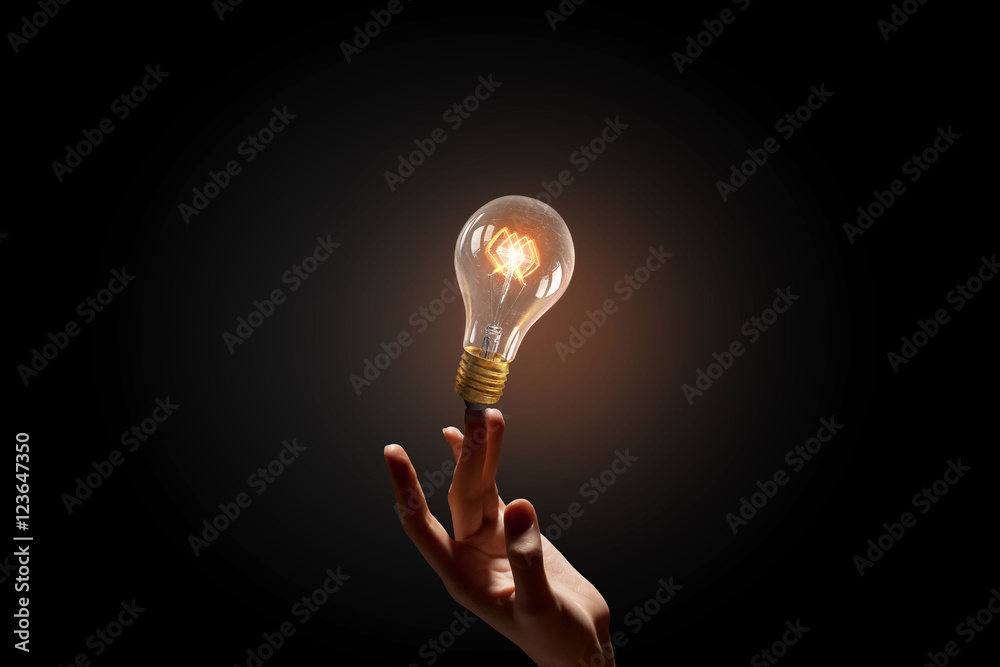 Wall mural hand pointing light bulb . mixed media