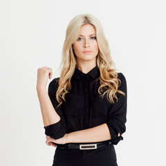 Serious and demanding business lady, looking at camera, white background. Place for you text on the right