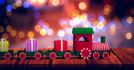 Composite image of train set with gift boxes