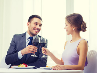 couple with main course and red wine at restaurant